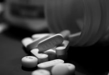 Antidepressant Use More Than Doubles Risk of Suicide Attempts A bottle of pills. Some are spilled out.
