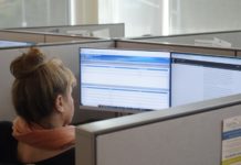 Suicide Hotline Sees Rise in Coronavirus-Related Calls. Counselors Feel the Pain crisis worker answers calls in a cubicle.