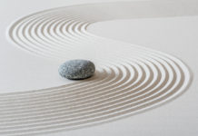 How Mindful Awareness Can Reduce Suffering stone in zen sand garden