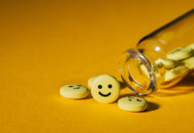 Insane Medicine, Chapter 5: The Manufacture of Childhood Depression (Part 2) spilled pills with happy faces on them