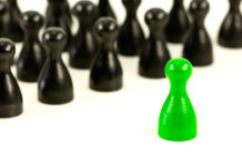 How and Why Neurotypicals Misunderstand and Mistreat Autistic People One green gamepiece facing many black gamepieces