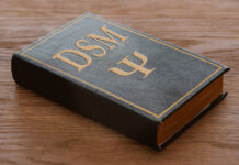 The DSM Files: Investigating the Incoherence of Psychiatry’s Bible A Bible-like book with "DSM" embossed on the cover