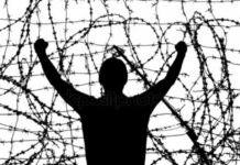 Institutionalized 18 Years Ago, I May Never Be Released silhouette of a man trapped against tangled barbed wire