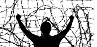 Institutionalized 18 Years Ago, I May Never Be Released silhouette of a man trapped against tangled barbed wire