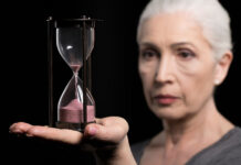 Peer Support Research: Is It Time Yet? An older woman holds an hourglass