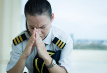 Psychiatry in Aeromedicine: Who Is Denied the Privilege of Piloting an Aircraft? Photo of a female pilot with her hands on her head, stressed/worried