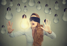 The Emperor’s New Clothes: The Upcoming NICE Depression Guidelines Concept illustration: Blindfolded young woman walking through lightbulbs