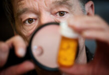 Antidepressant-Induced Serotonin Syndrome a Danger for the Elderly Man closely examing instructions on prescription medications