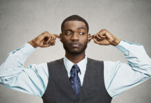The Phobic Avoidance of Attending to Real World Mental Health Outcomes A black man stands with fingers in his ears as if pretending not to hear