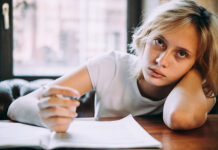 A Developmental Response to Trauma and Trauma Language A teenage girl writing