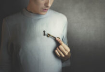 Why We Urgently Need New Approaches to Mental Health Illustration depicting a keyhole in a person's shirt/chest. They are holding an old-fashioned skeleton key near it.