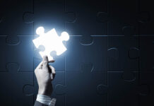 Our RCT Fetish: How the “Gold Standard” for Research Has Led to A Societal Delusion About the Merits of Antidepressants Close up of businessman hand holding glowing jigsaw element
