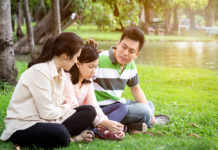 Q&A: How Can I Best Support My Child’s Withdrawal from Psychiatric Drugs? Asian mom and dad comforting daughter on grass in a park