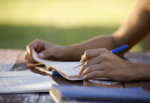 6 Good Things That Happened When I Stopped Believing in ‘Mental Health’ Close-up photo of hands writing in a journal or notebook