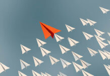 Improving Therapy Outcomes: The Case for Deliberate Practice Illustration of paper airplanes flying diagonally as a fleet from bottom right toward upper left. One plane in the lead is colored orange.