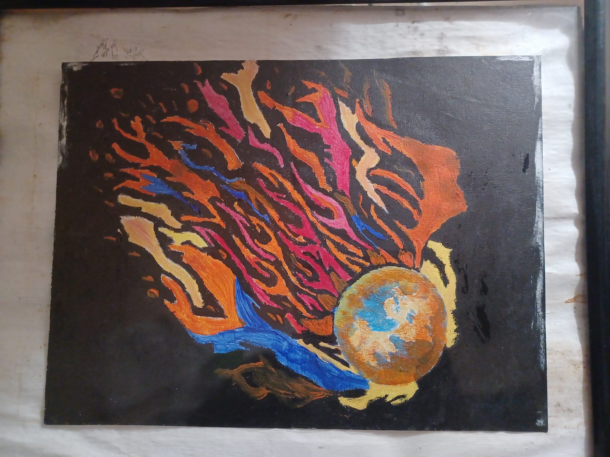 Ball with flames coming out, colored pink tan and orange