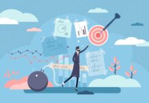 The Mental Health Industry Speaks Volumes About Our Society’s Priorities Illustration of a man in a suit with a weight chained to his leg. He is reaching for graphs and dartboards against a blue background.