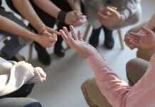 When Violence Hits Home, Can We Keep Growing? Close-up of therapist's hands explaining a problem to his patients