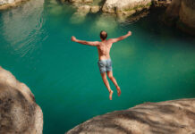 Life-Enhancing Anxiety: Key to a Revitalized World Photo of a man leaping off a rock into green water