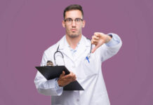Self-test for Adult Symptom Deficiency Disorder (ASDD) Handsome young doctor man holding a clipboard with angry face, negative sign showing dislike with thumbs down, rejection concept