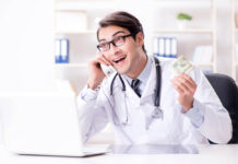 Critical Psychiatry Textbook, Chapter 7: Psychosis (Part Four) Stock photo of a doctor holding money and talking on the phone