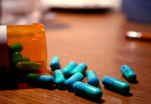 Critical Psychiatry Textbook, Chapter 8: Depression and Mania (Affective Disorders) (Part Four) A bottle of blue pills overturned on a wooden table