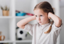 Critical Psychiatry Textbook, Chapter 8: Depression and Mania (Affective Disorders) (Part Five) Photo of a white child covering ears with hands