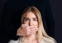 “Borderline Personality Disorder” and Survivor Injustice A white woman's face. A man's hand over her mouth.
