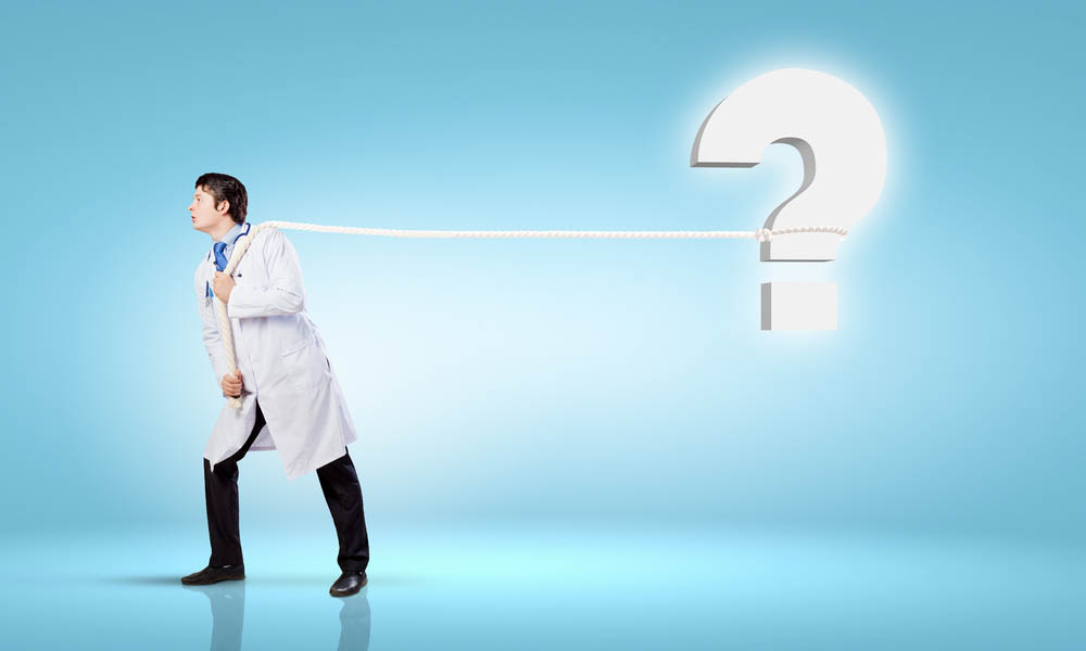 Image of male doctor pulling question sign with rope