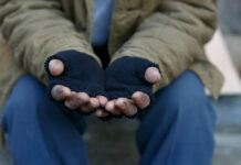 Psychiatry, Violence, and the State: California’s Systematic Failure of Its Unhoused Population Closeup on gloved hands held up as if asking for help