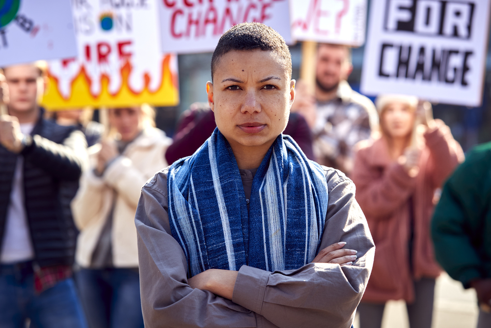 Group Of Protestors With Placards On Demonstration March Against Climate Chane