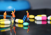 Much of U.S. Healthcare Is Broken: How to Fix It (Chapter 2, Part 2) Miniature people - The worker at work with medicine pills