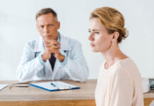 “Impairment: Says Who?”: The Fundamental Question of Mental Health Treatment A male doctor looks slightly angry at a woman who looks sad in profile