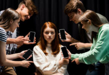 “A Dangerous Substance”: The Impact of Social Media on Youth Mental Health Photo of a girl surrounded by bullies holding cell phones