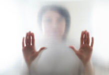 Psychosis Treatment: Numbing the World of Spirit Diffused silhouette of female hands through frosted glass