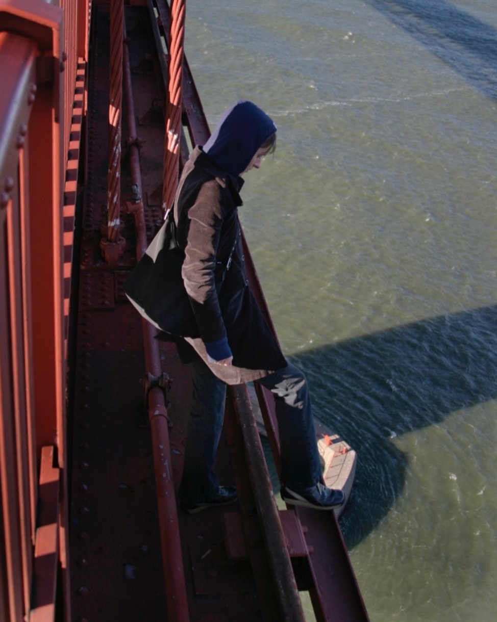 person standing on edge of the Golden Gate Bridge