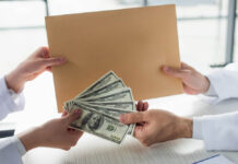 Major Medical Journals’ Peer Reviewers Received Over $1 Billion in Industry Funding Doctors exchange money and an envelope