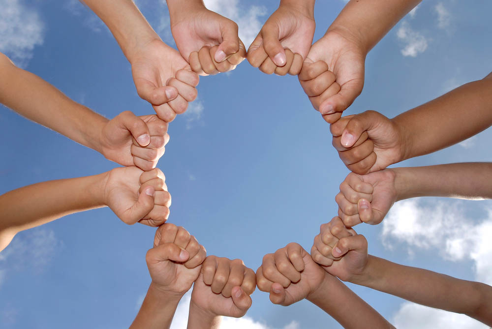 Hands together against the sky