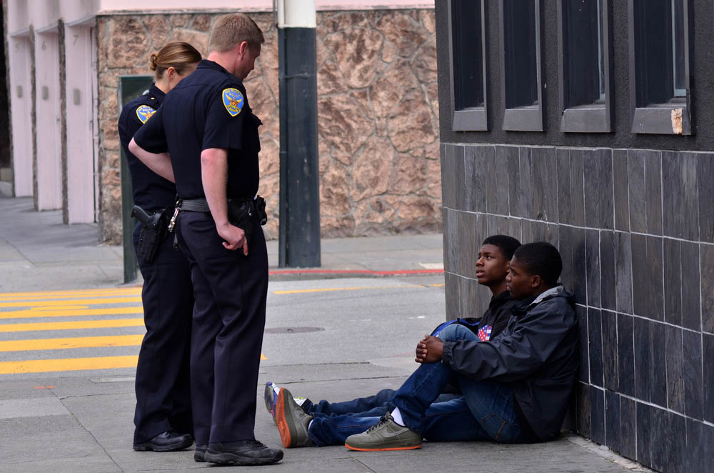 SAN FRANCISCO - MAY 15 2015:SFPD officers interrogating black american men in San Francisco. Overall, Black Americans are arrested at 2.6 times the per-capita rate of all other Americans.