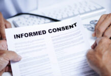 Who Can Consent to Research—and What Does That Mean for Forced Treatment? Close up of document titled "Informed Consent" being held