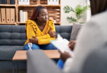 Beyond Cultural Competence: A New Model Demands Psychology Take on Systemic Oppression African american women psychologist and patient having mental therapy sitting on sofa at psychology clinic