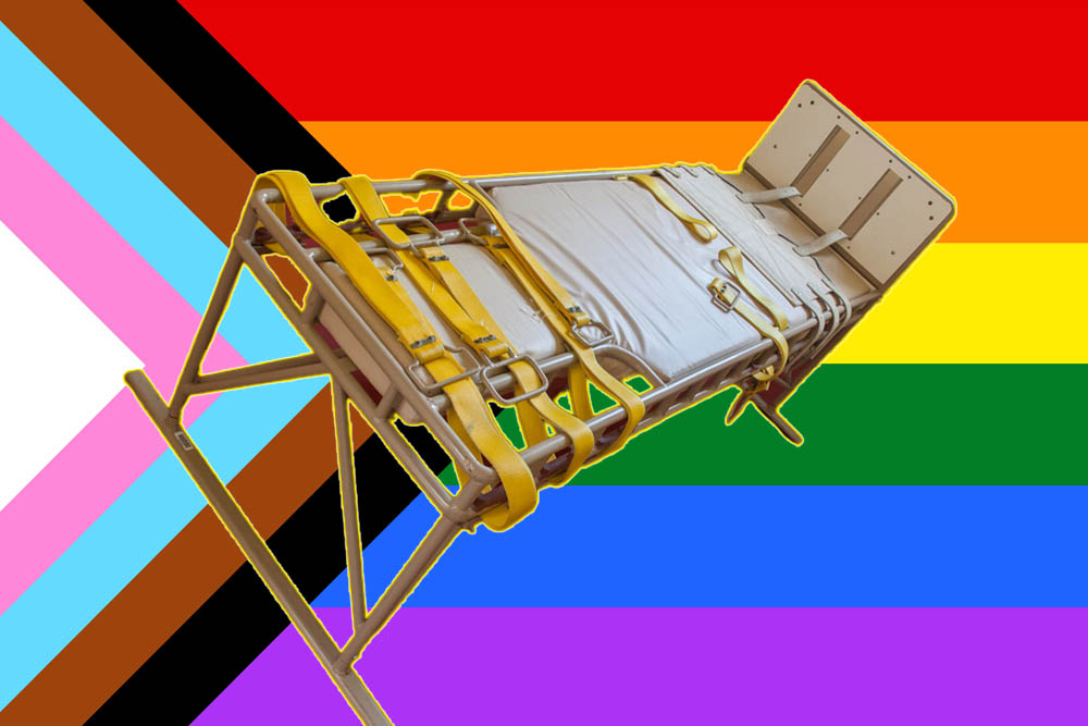 A hospital bed with restraints. The background is a pride flag with all colors.