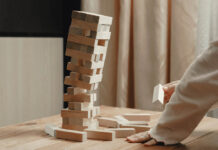 From Public Service to Private Practice: The Collapse of the Social Work Profession A jenga tower of bricks begins to collapse