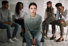 The Quiet Crisis in Mental Health: The Medicalization and Deskilling of Psychotherapy Photo of young woman in a therapy group