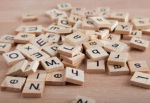 Lost in Psychobabble? Cut Through the Jargon for Real Mental Clarity Pile of Scrabble letter blocks on wood background.