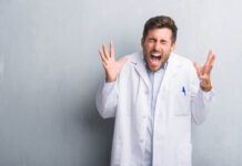 Criticisms That Establishment Psychiatry Can and Cannot Tolerate Stock photo. Man in lab coat appears to scream in anger.