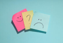 Beyond the Pill Paradigm: Reclaiming Humanity in Mental Health Care Sticky notes on blue background. One shows a smiley face, one a frown, and one between them depicts a question mark.