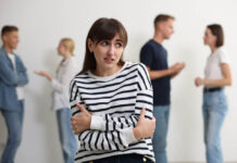 Being Anxious About Socializing Is Not Autism Young woman feeling uncomfortable among people indoors, selective focus