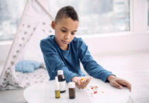 Usage of Depression Pills in Children and Young People Must Stop Upset Black boy holding pills