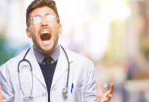 Are Psychiatrists More Mad Than Their Patients? A male doctor appears to scream in frustration. His glasses catch the light